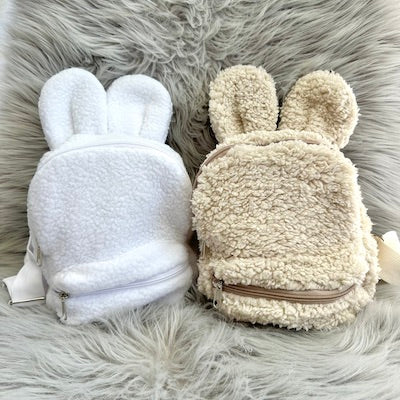 2 baby backpacks with teddy ears (white and oat) made with fluffy teddy bear fabrics.