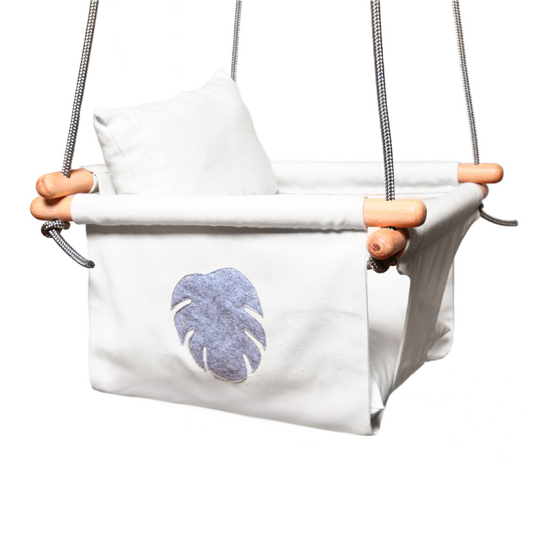 White with grey monstera leaf swing with grey ropes, and wooden dowels.