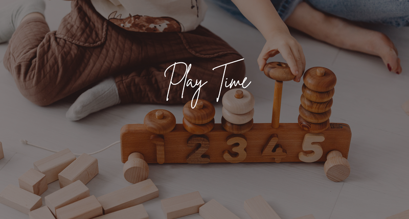 Toddler playing with wooden counter toy