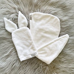 White wash mitt with bunny ears and a white hair wrap.