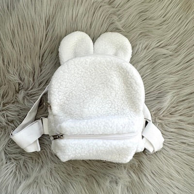 White baby backpacks with teddy ears made with fluffy teddy bear fabrics.