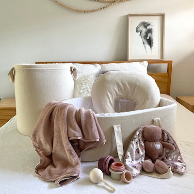 Cotton basketweave carry cot with white interior.
