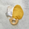 Hard wood teething ring and soft bird wings made from cotton mustard muslin and white satin.
