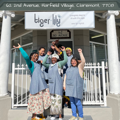 Happy Tiger Lily Tots team standing outside studio in Harfield village Cape Town