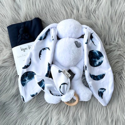 White with Moons Bunny Gift Set includes: ears teether, bunny and navy swaddle set.