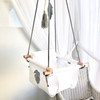 White with grey monstera leaf swing with grey ropes,  and wooden dowels.